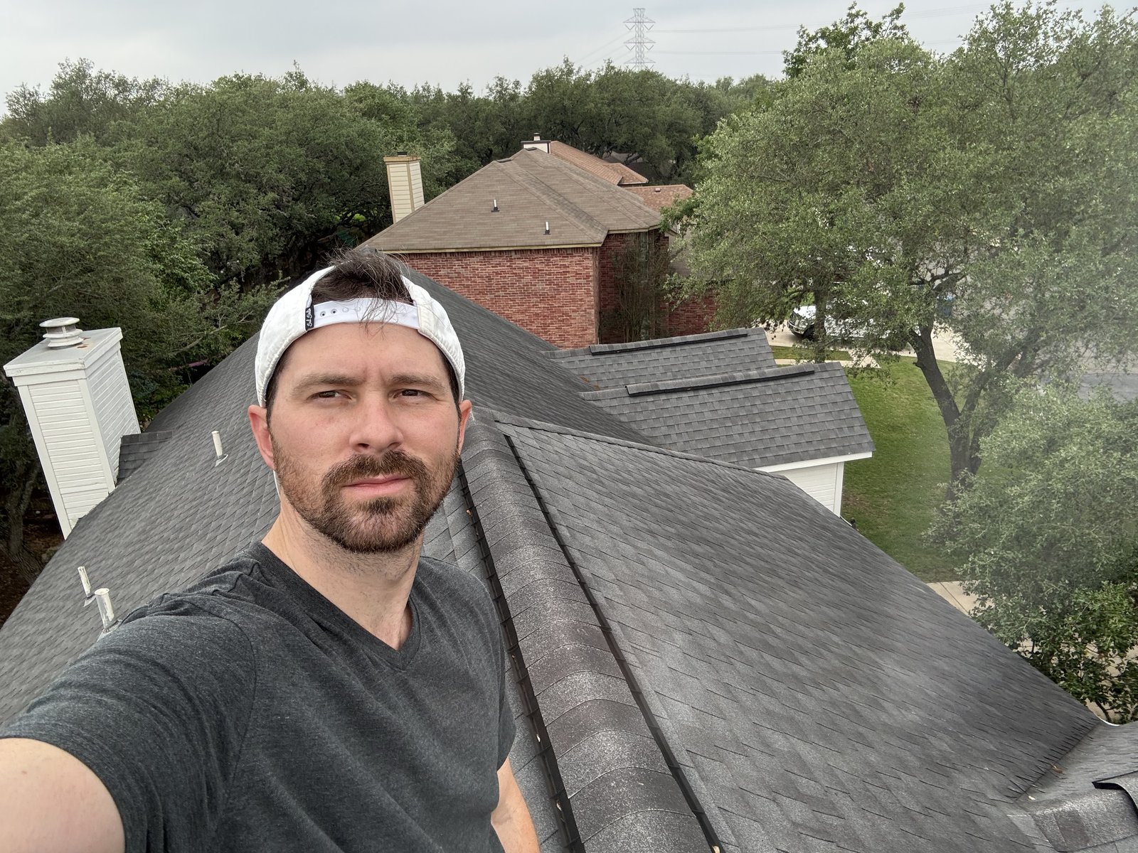 Kyle Watters standing on a residential rooftop in San Antonio
